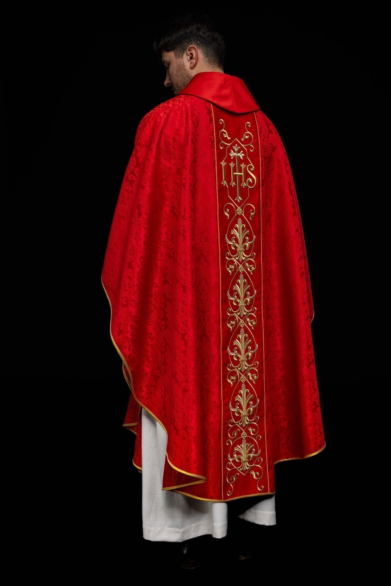 Casulla roja con bordado IHS ; la tela decorativa